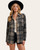 Front view of a woman wearing a grey mix women’s plaid shacket layered over a cream tank and black denim shorts, showcasing classic flannel texture from Trendy Threads Roscoe, South Dakota. Front view of a woman wearing a grey mix women’s plaid shacket layered over a cream tank and black denim shorts, showcasing classic flannel texture from Trendy Threads Roscoe, South Dakota.