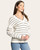 Cozy striped ivory V-neck sweater – side profile. Cozy striped ivory V-neck sweater – side profile.