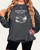 Woman wearing Christian graphic sweatshirt that reads “He Restores My Soul” in charcoal color