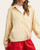 Woman modeling the lightweight Aviril yellow striped spring jacket over a tee.