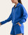 Side view of the Laguna Scuba Pullover in Cobalt showing the drop-shoulder silhouette and matching shorts.