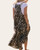 Back view of the Louisa leopard print overall maxi dress showing the flowy tiered skirt.