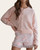 Side view of a woman wearing the ultra-soft Layla light pink crew neck cardigan, showing the relaxed fit.