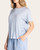 Side angle of a model wearing the relaxed fit, striped Opalite t-shirt with hands in pockets.