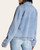 Back view of a model wearing the Thread and Supply Violet Denim Jacket in light washed denim.