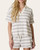 Front view of a blonde model wearing the relaxed fit Maybel striped collared shirt for women.