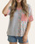 Woman wearing the Spring Magic V-Neck Top featuring a split design of blue stripes and spring florals with a v-neckline, front view.