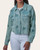 Front view of a woman wearing the button-down washed emerald double gauze jacket with floral embroidery over white pants.