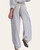 Back view of a woman wearing relaxed fit striped soft wash linen pants with an elastic hem.