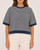 Model wearing the short sleeve striped spring knit top in navy and cream facing forward.