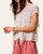 Side angle view of the women's ivory lace ruffle tiered spring top.