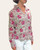Side profile of the 100 percent cotton Capri Pink floral button down shirt showing rolled full-length sleeves on a model.