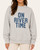 Front view of the On River Time Mock Neck Sweatshirt in heather grey with blue block lettering, styled on a model.