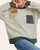 Close up of the ultra-soft Desirae striped pullover showing the olive chest pocket, banded hem, and cuffs.