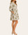 Side view of the sage botanical print pintuck dress highlighting the functional side pockets and 3/4 length elastic cuff sleeves.