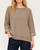 Woman modeling a comfortable, oversized mocha short sleeve sweatshirt paired with dark denim.