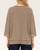 Back view of a woman wearing an oversized mocha short sleeve sweatshirt with inverted seam details.