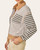 Side view of the women's Ladylike Striped Polo Top showing drop shoulders and cuffed sleeves