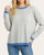 Front view of model wearing the Kayla striped crew neck sweater in grey and blue.