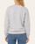 Back view of women's heather ash fleece lined sweatshirt paired with blue jeans