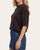 Side profile of a woman modeling the comfortable dark chocolate Lyla short sleeve knit sweater.