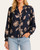 Woman wearing the navy Winslow floral blouse with smocked v-neckline and light wash jeans