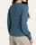 Back view of the ribbed mallard blue Tana Top by Thread and Supply with full-length cuffed sleeves.