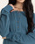 Woman styling the mallard blue Tana Top by Thread and Supply tucked into comfortable pants.