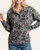 Woman modeling the front of the dark charcoal Peace Gardens Leafy Print Hooded Top with neckline button details.