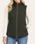 Front view of a model in the Dark Olive Quilted Zip Up Vest, with a full zipper, stand collar and front pockets.