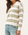 Side view of the Nadine Striped Polo Sweater on a model, showing the relaxed drape, long sleeve and multicolor stripes.