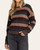 Front view of a model wearing the Thread & Supply Carlisle Sweater with tan, burgundy and charcoal stripes and a round neckline.