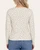 Back view of a model wearing the cream Leaf Print Long Sleeve Top, with petite leaf motifs across the back and sleeves.