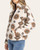 Side view of the Thread & Supply Rivera Jacket on a model, showing the printed fleece sleeve, half-zip neckline and side pocket.