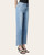 Angled view of Lovervet High Rise Jeans (Paige), showing light distressing near the front pocket and frayed front hem cutouts.