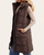 Side angle of the Detachable Hood Longline Puffer Vest, showing a front welt pocket, hood and side-hem snaps.
