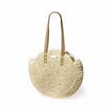 A round, off-white woven tote bag with tan straps and a simple logo. A round, off-white woven tote bag with tan straps and a simple logo.