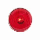 A red circular light with a textured surface and a central yellow bulb. It features a logo on the back.