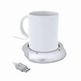 A white mug placed on a silver USB-powered warmer with a connected USB cable. A white mug placed on a silver USB-powered warmer with a connected USB cable.