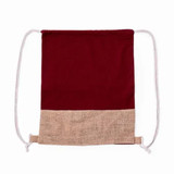 A drawstring bag featuring a maroon cotton top and a jute bottom, complete with white drawstrings.