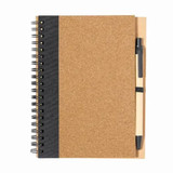 A cork-covered notebook with a black side and a black pen attached, featuring a spiral binding.