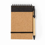 A cork notebook with a spiral binding, featuring a black top section and a pen attached by an elastic band.