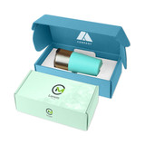 A teal drink bottle sits inside a teal and white packaging box, with a logo on the packaging.