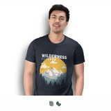 A man wearing a navy blue TRENDSWEAR Original men's T-shirt featuring a mountain and forest graphic design.