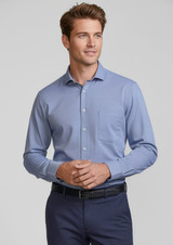 A blue long sleeve button-up shirt with a chest pocket, worn by a smiling man. The shirt features a logo.