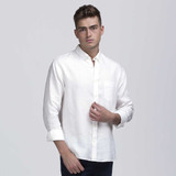 A light-coloured linen button-up shirt with long sleeves and a chest pocket. The model is posing against a plain background. A light-coloured linen button-up shirt with long sleeves and a chest pocket. The model is posing against a plain background.