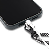 A close-up of a phone with a black and white patterned crossbody strap attached, featuring a connector at the base. A close-up of a phone with a black and white patterned crossbody strap attached, featuring a connector at the base.