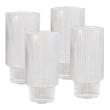 A set of four clear ribbed highball glasses, featuring a textured design and a thick base.