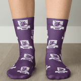 Purple socks featuring a pattern with lions and logos, showcasing a vibrant design and comfortable fit.