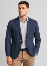 A navy blue men's blazer with a slim fit, featuring two buttons and side pockets, worn over a checked shirt.